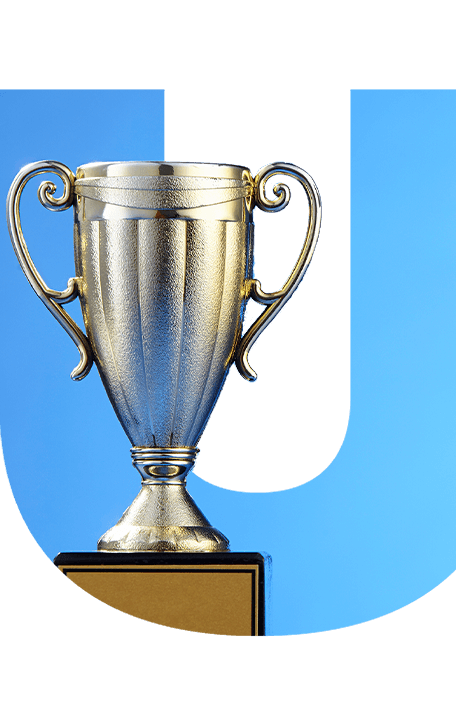 mounted metallic trophy cup in front of a blue letter "U"